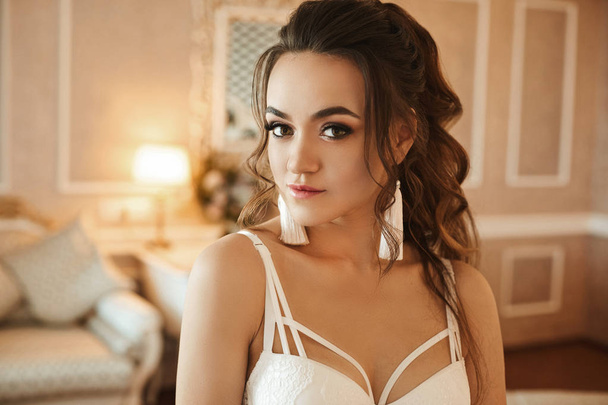 Sexy young model woman with perfect body and with wedding hairstyle in a trendy and stylish lace bra posing at luxury vintage interior - Фото, изображение