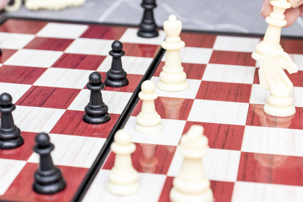 Chess board with figures on it close up, intellectual board games and hobby concept - Photo, image