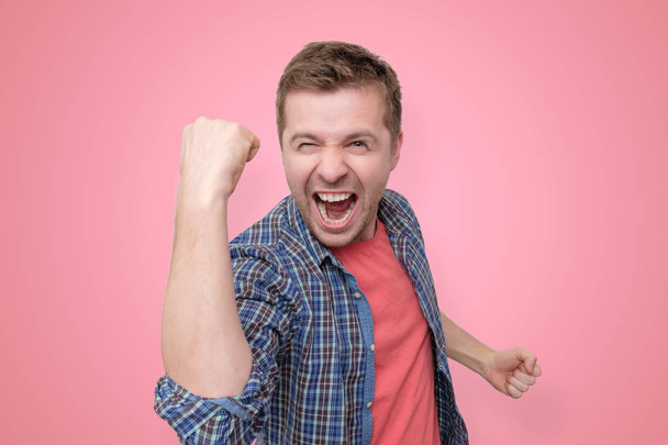 man looking so excited putting his fist up - Foto, immagini