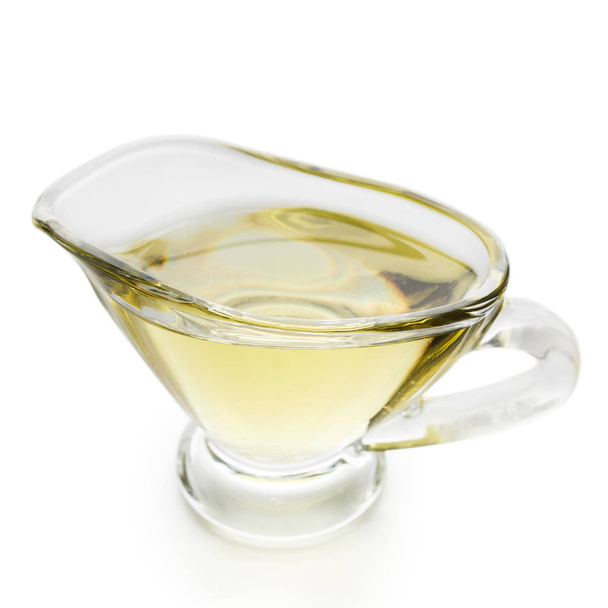 Aceite de oliva en frasco de vidrio sobre blanco
 - Foto, imagen