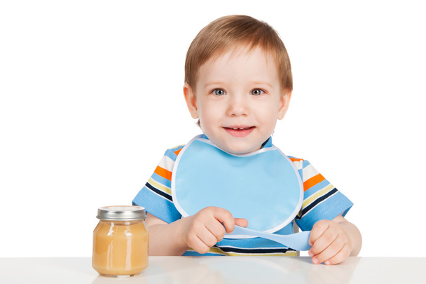 Boy eats with a spoon puree - Fotografie, Obrázek