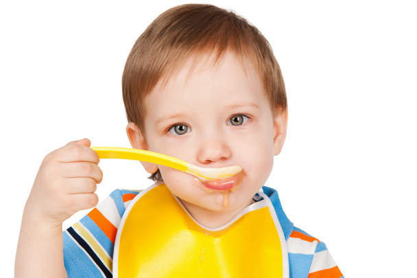 Boy eats with a spoon puree - Zdjęcie, obraz