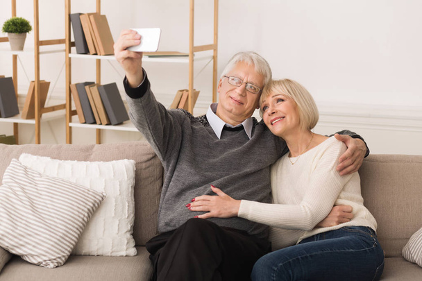 現代の祖父母電話で自分撮りをする高齢のカップル - 写真・画像