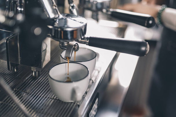 Drops of coffee falling into the cups on the coffee machine - Фото, зображення