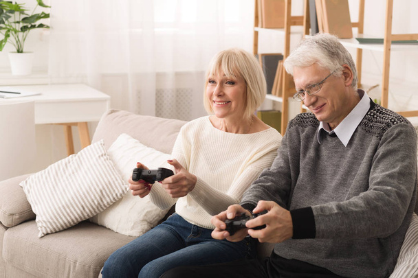 Having Fun. Senior Couple Playing Video Games - Fotó, kép