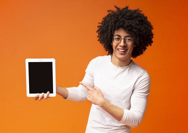 Cheerful african-american man showing cool modern digital tablet - Photo, image