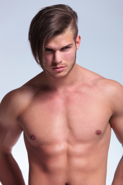 topless young man stands with hands at back - Photo, Image