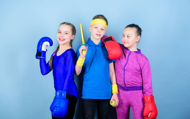 Fitness energy health. punching knockout. Team sport success. workout of small girls boxer and boy in sportswear. Happy children in boxing gloves with tennis racket and ball. boxing - Φωτογραφία, εικόνα