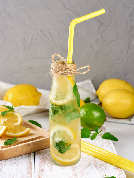 zimny napój z cytryny, liście mięty, wapno w szklanej butelce - Zdjęcie, obraz