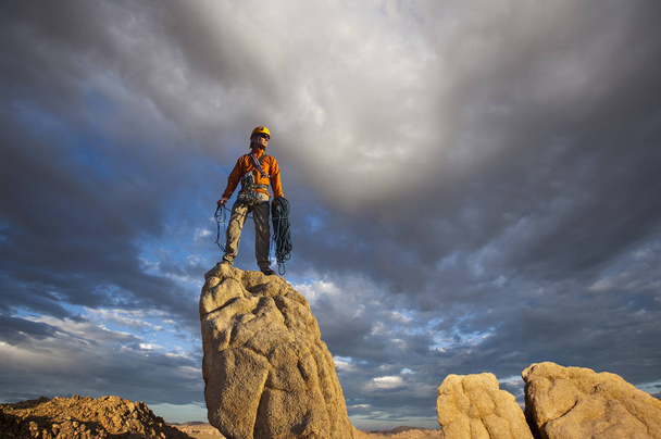 Rock climber celebrates on the summit. - Photo, Image