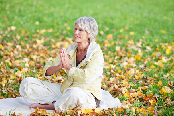 Senior Woman With Hands Clasped Meditating Outdoor - Fotoğraf, Görsel
