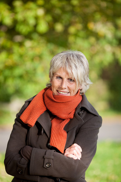 Senior Woman Shivering In Park - Foto, immagini