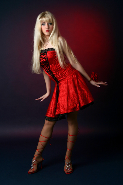 Young blonde in a red satiny dress - Zdjęcie, obraz
