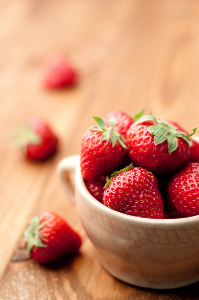 Strawberries in a Bowl, ona a wooden background - Foto, Imagem