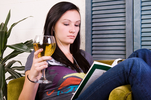 Cute Girl Drinking while Reading a Book - 写真・画像