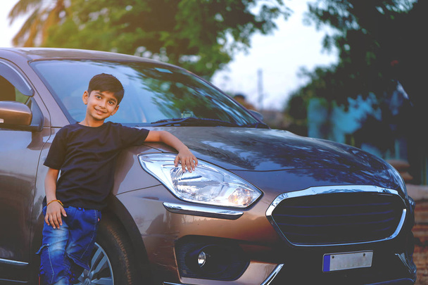 Cute Indian child with car - Foto, Imagen