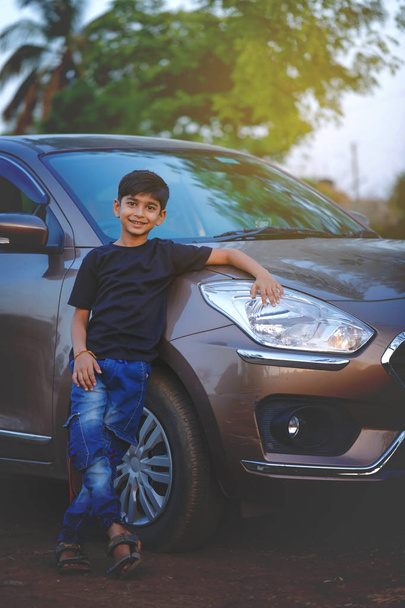 Cute Indian child with car - Foto, afbeelding