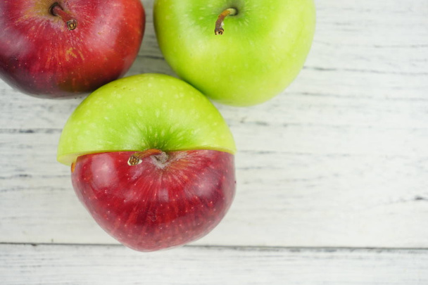 Red and green apples on wooden background texture. Healthy Food  - Photo, Image