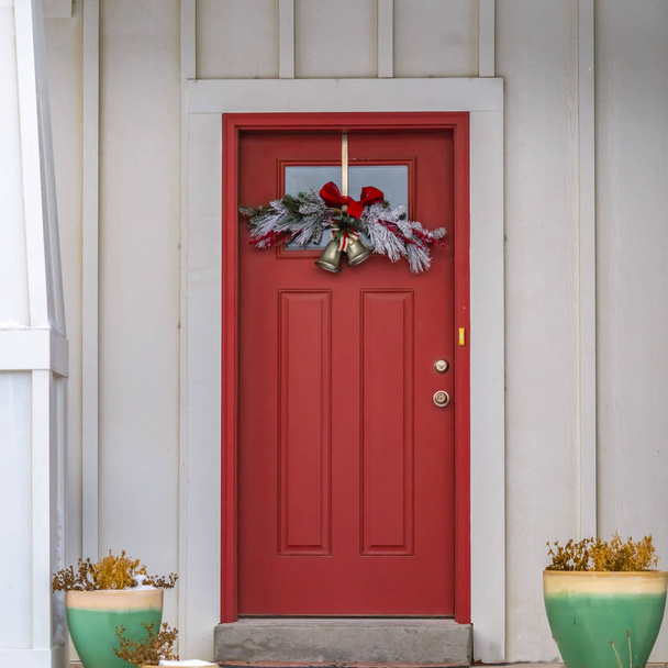 Clear Square Front door with glass panel and holiday decoration against a ribbed white wall - Photo, Image