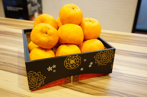 Mandarin oranges inside beautiful wooden tray for Chinese New Year celebration - Photo, Image