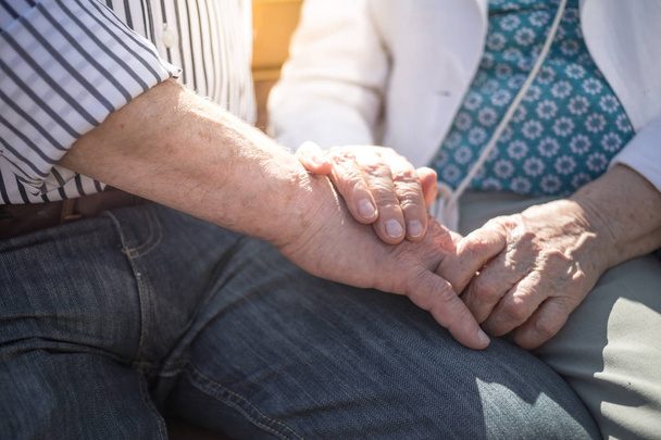 Elderly couple holding hands outdoors. Senior adults - Photo, Image