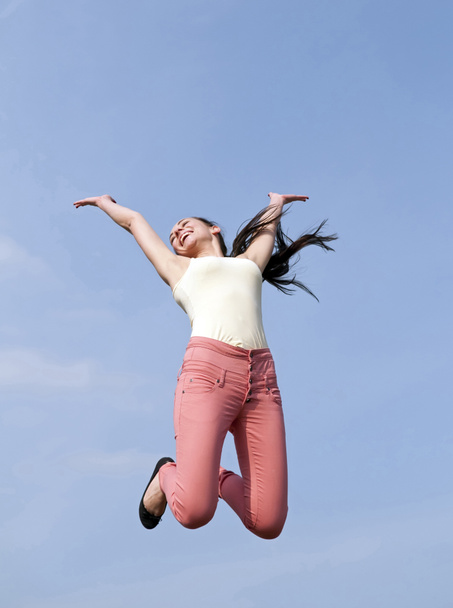 Woman jumping into the blue sky - Photo, Image