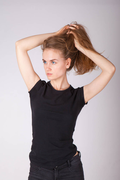 studio portrait of a slim young woman in black clothes - Foto, Imagem
