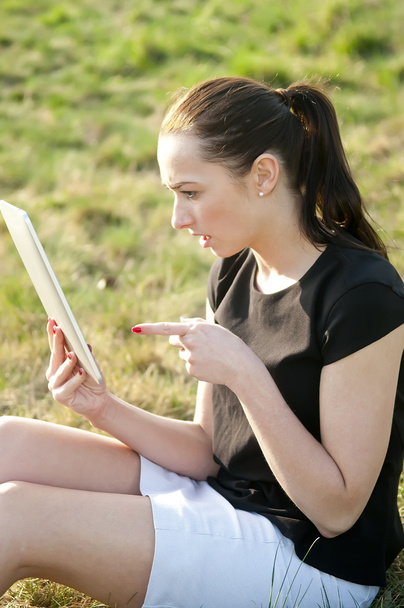 Woman with tablet pc on a meadow - Photo, Image