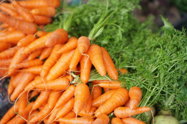 Fresh and sweet carrot for sale on local market. Selective Focus - Foto, Imagen