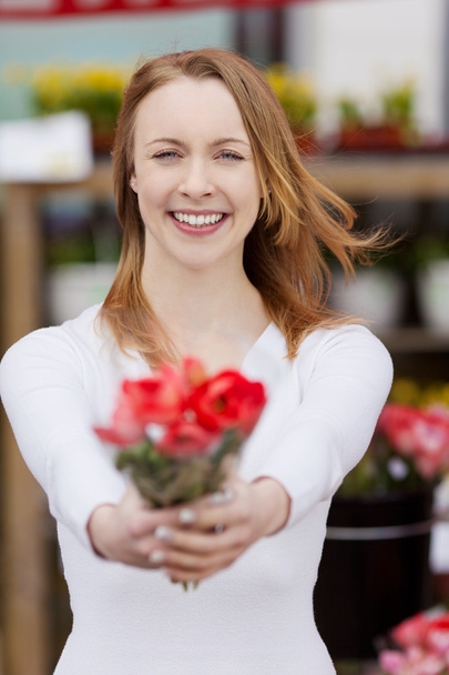 Attractive young woman showing a bunch of flowers - Photo, Image