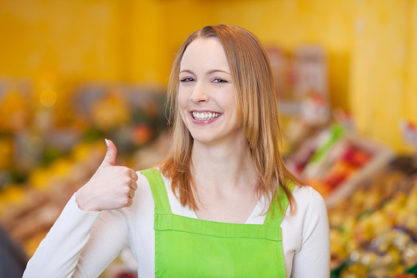 Female Worker Showing Thumbsup Gesture In Grocery Store - Photo, image