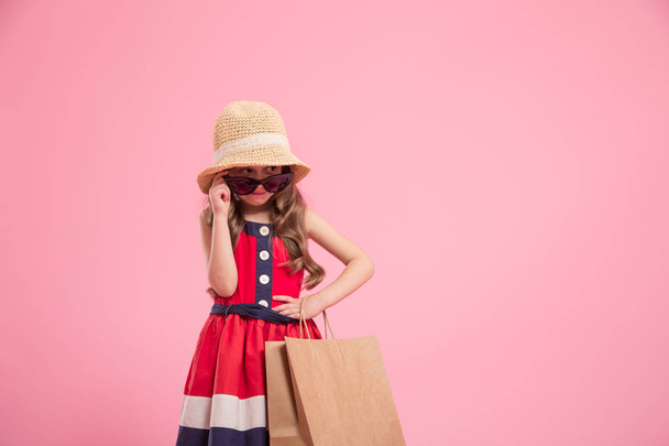 little fashionista on a colored background in mom's shoes - 写真・画像