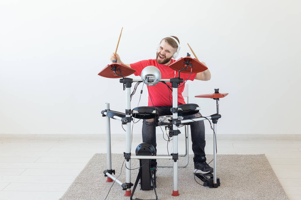 People, free time and hobby concept - Cool male drummer over white room background - Photo, Image