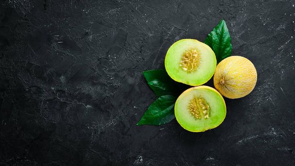 Fresh melon on black background. Top view. Free space for your text. - 写真・画像