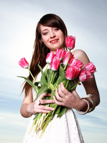 Smiling woman with bunch of flowers - Φωτογραφία, εικόνα