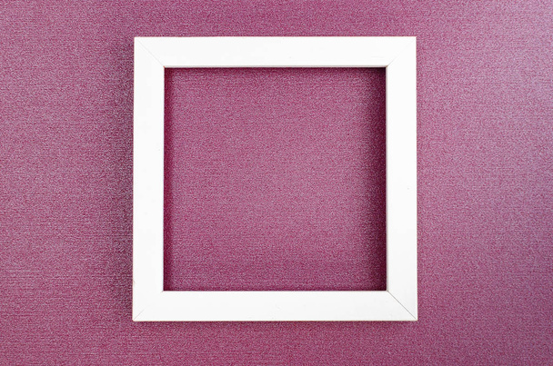 square wooden frame on the purple pearl paper background - Foto, imagen