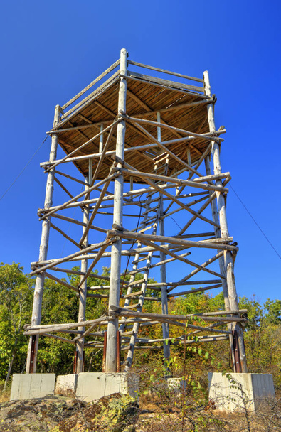 Wooden tower structure on blue sky - Photo, Image