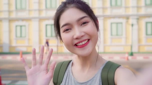 Asian blogger woman travel in Bangkok, Thailand, backpacker female using mobile phone make vlog and live in social media while spending sweet time in holiday trip. Women travel in city concept. - Footage, Video