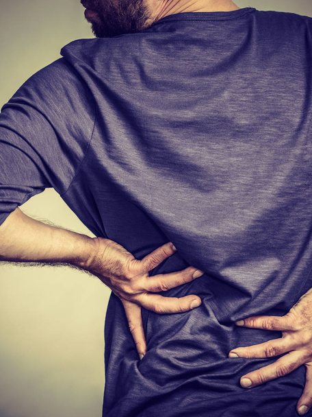 Man having back loins pain ache - Fotó, kép