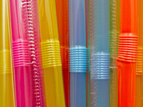 Many multicolored plastic straws. Close up macro. Plastic straws are being banned in various countries around the world. - Photo, Image
