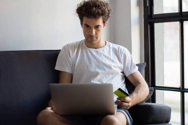 Young man relaxing on the sofa with a laptop  - Foto, Imagem