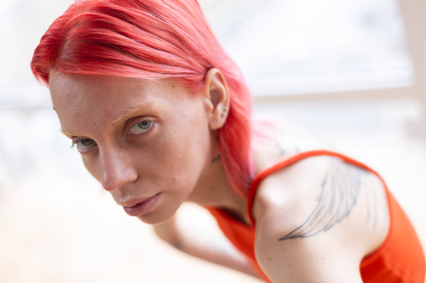 Woman wearing red top feeling unwell suffering from anorexia - Fotoğraf, Görsel