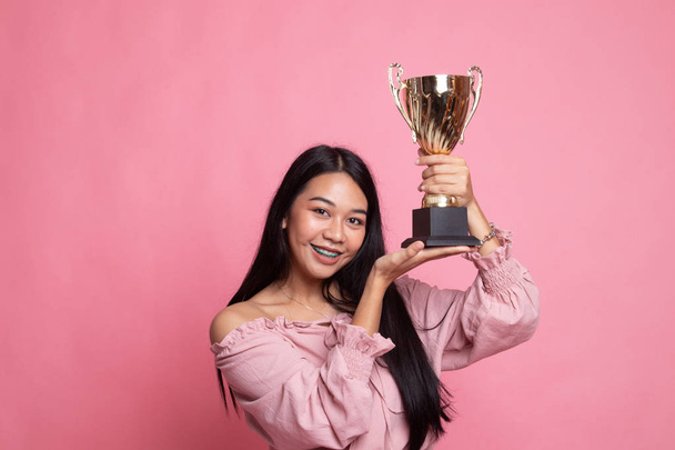 Successful young asian woman holding a trophy. - Photo, Image