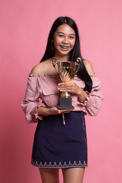 Successful young asian woman holding a trophy. - Fotografie, Obrázek