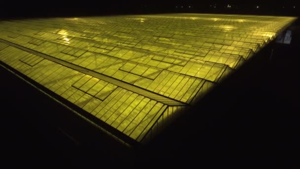 Beautiful aerial view of the large greenhouse with light in it. - Footage, Video