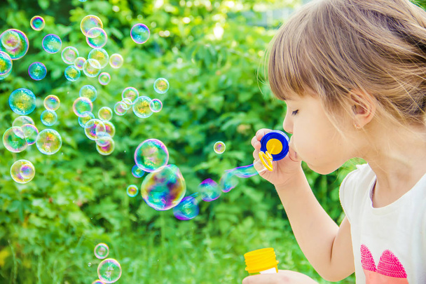 The children are blowing bubbles. Selective focus. - Photo, Image