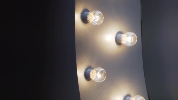 View of several cute orange lightbulbs mounted to part of arch shaped grey wall. - Footage, Video