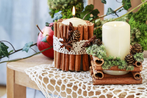 Candle decorated with cinnamon sticks - Photo, image