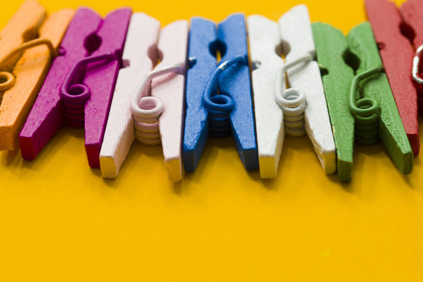 colored clothespins on a yellow background - Photo, Image