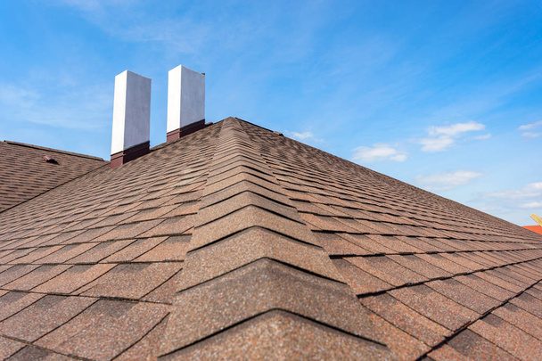 Asphalt tile roof with chimney on new home under construction - Photo, Image